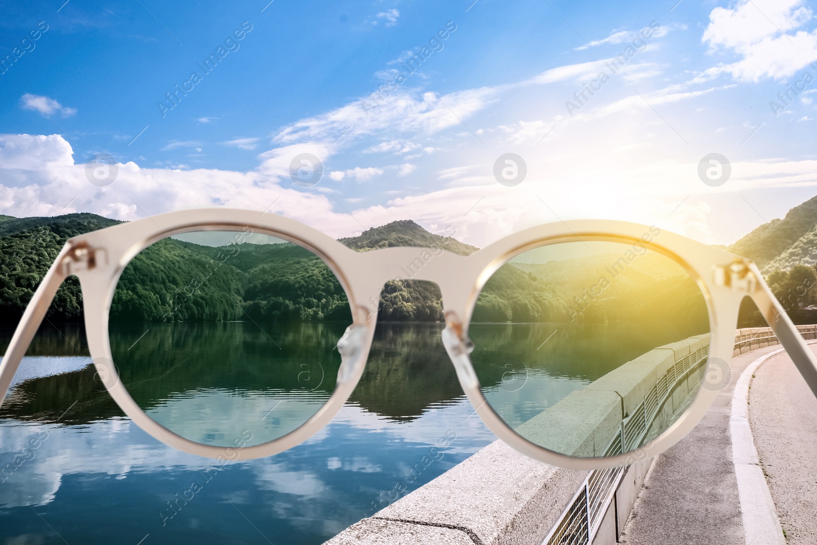 Image of Road along lake on sunny day, view through sunglasses