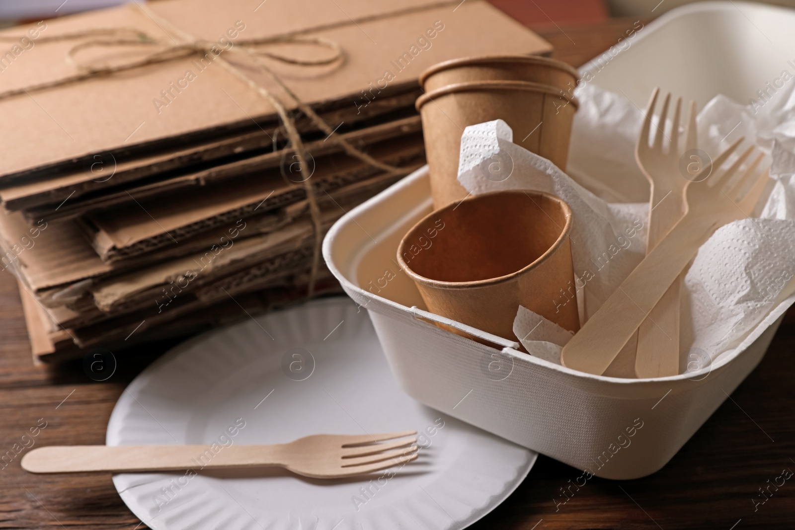 Photo of Heap of waste paper on wooden table, closeup