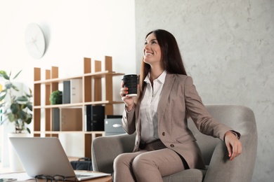 Female business trainer working with laptop in office