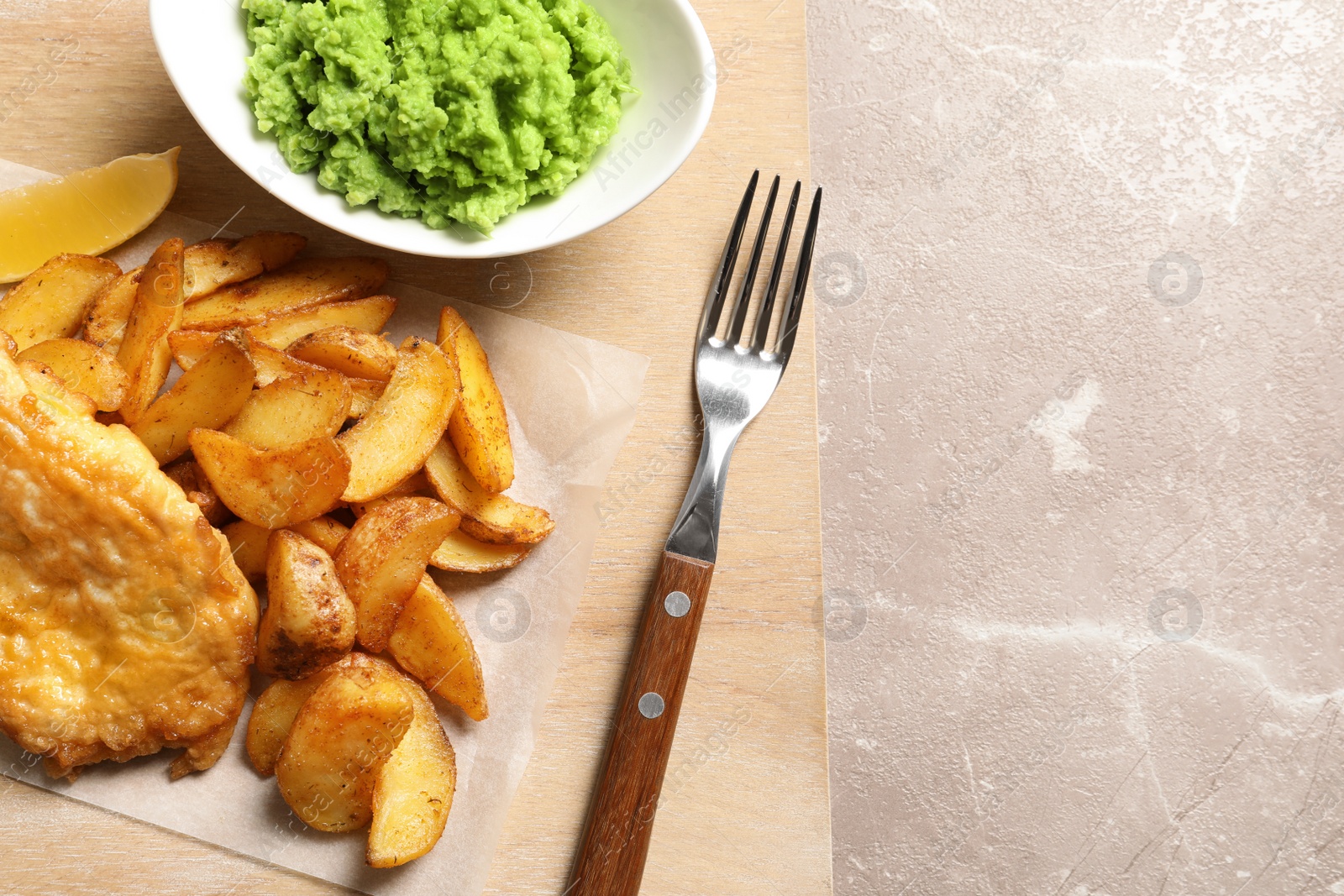 Photo of British traditional fish, potato chips and mushy peas on color background, top view. Space for text