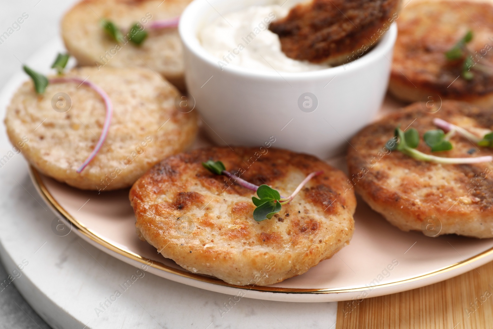 Photo of Delicious vegan cutlets and sauce on table, closeup