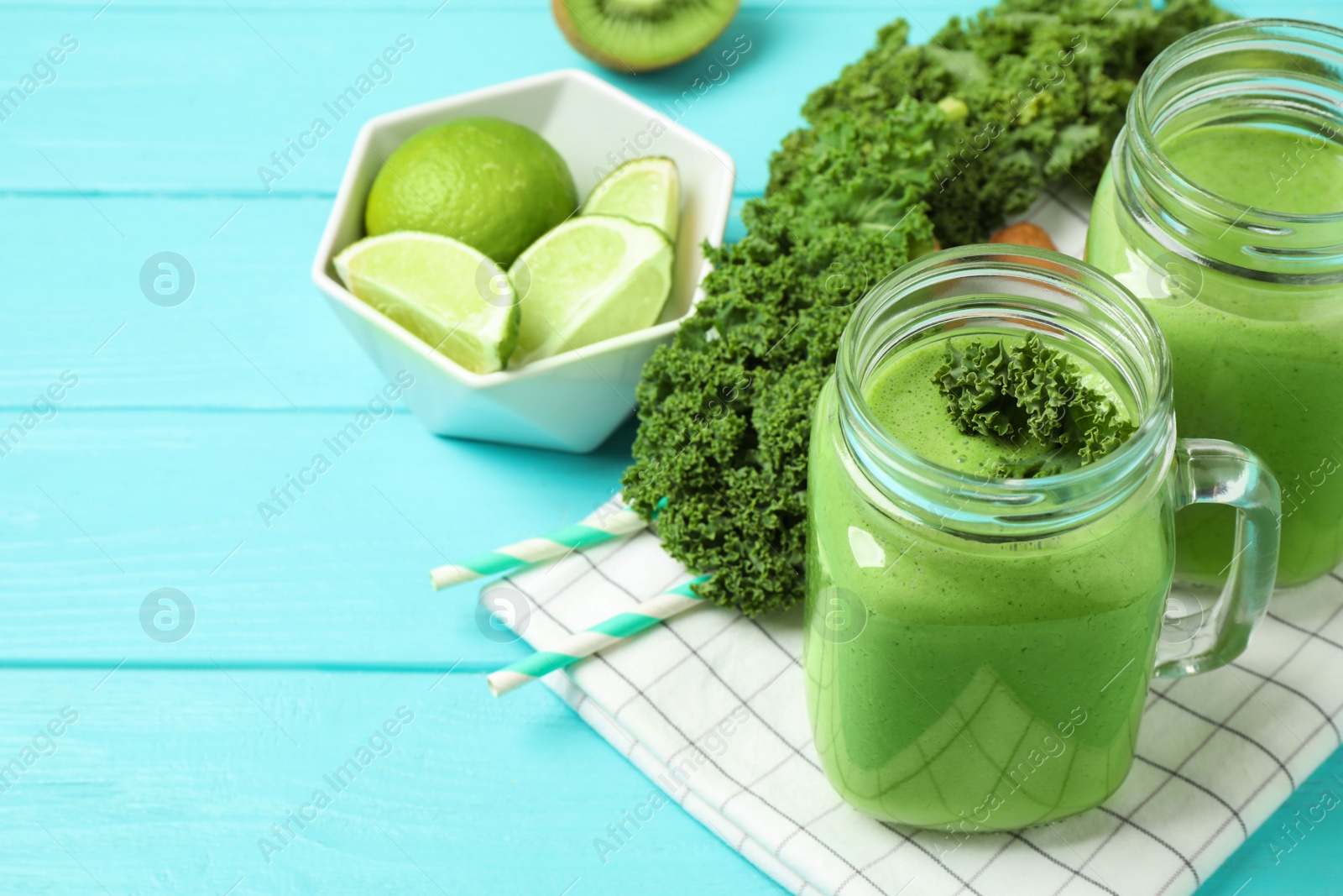 Photo of Tasty fresh kale smoothie on light blue wooden table