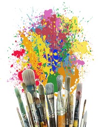 Image of Different brushes and paint splatters on white background