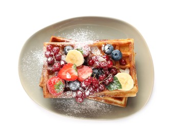 Photo of Plate of delicious Belgian waffles with berries and powdered sugar isolated on white, top view
