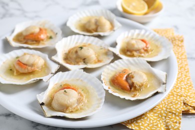 Fried scallops in shells on white marble table, closeup