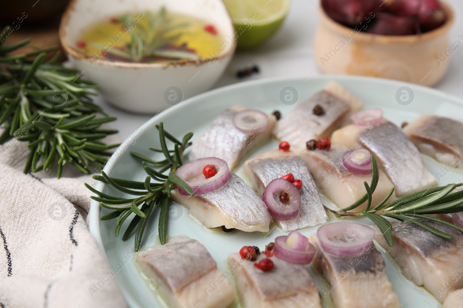 Photo of Tasty marinated fish with rosemary and spices on light table, closeup