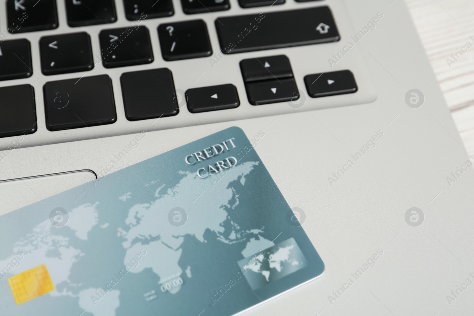 Photo of Online payment concept. Bank card on laptop keyboard, closeup