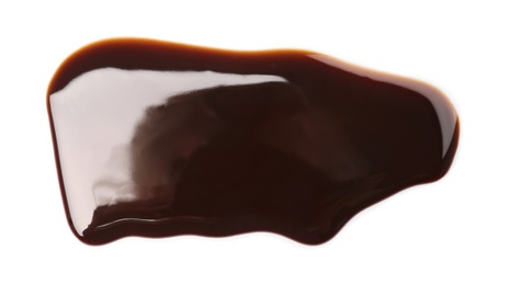 Photo of Flowing chocolate sauce on white background