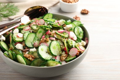 Photo of Delicious cucumber salad served on wooden table, closeup