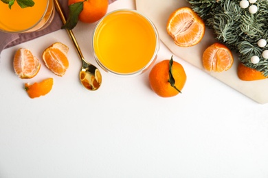 Photo of Delicious tangerine jelly and fresh fruits on white table, flat lay. Space for text