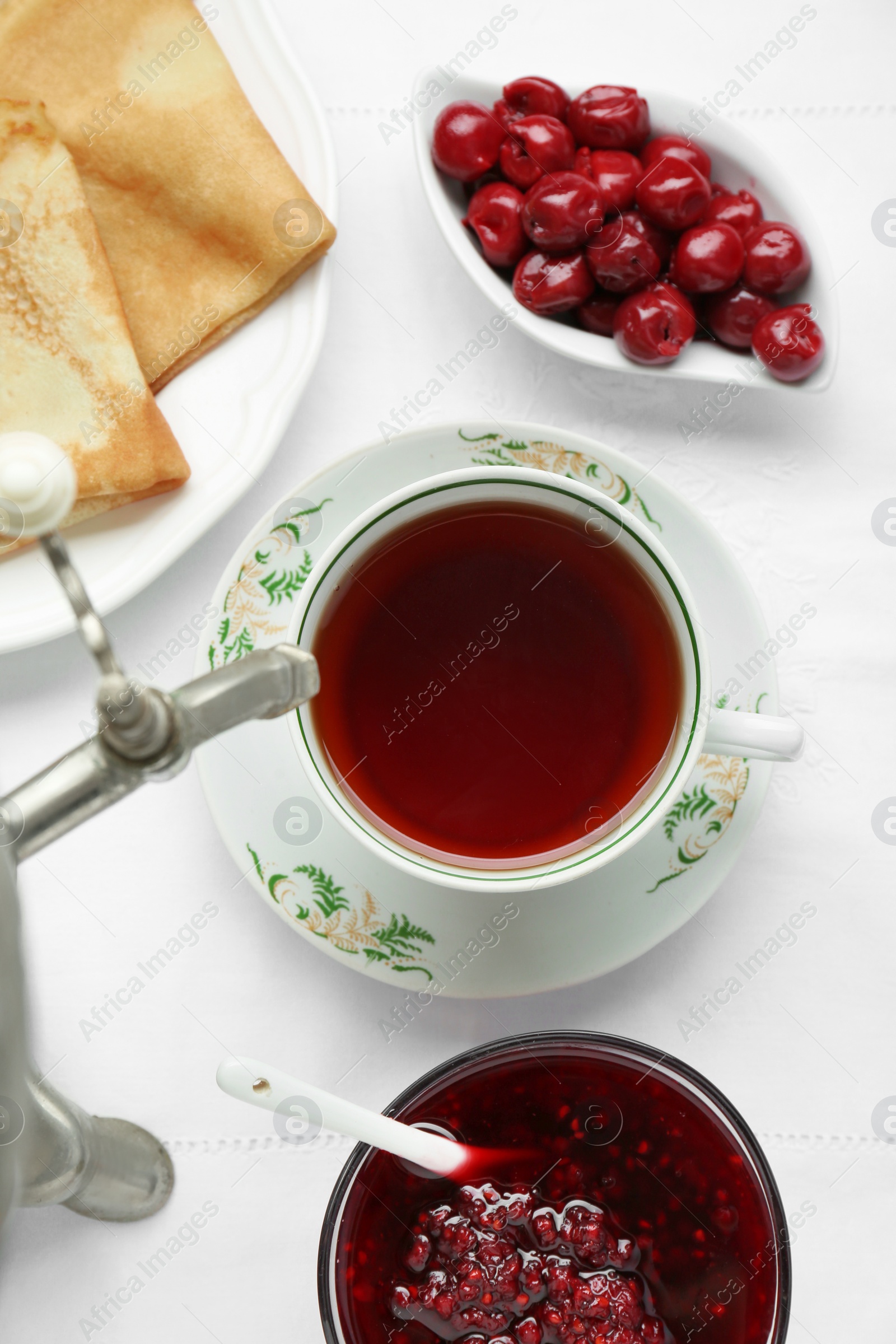 Photo of Cup of aromatic tea and treats on table, flat lay