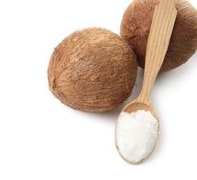 Photo of Spoon with coconut oil and nuts on white background