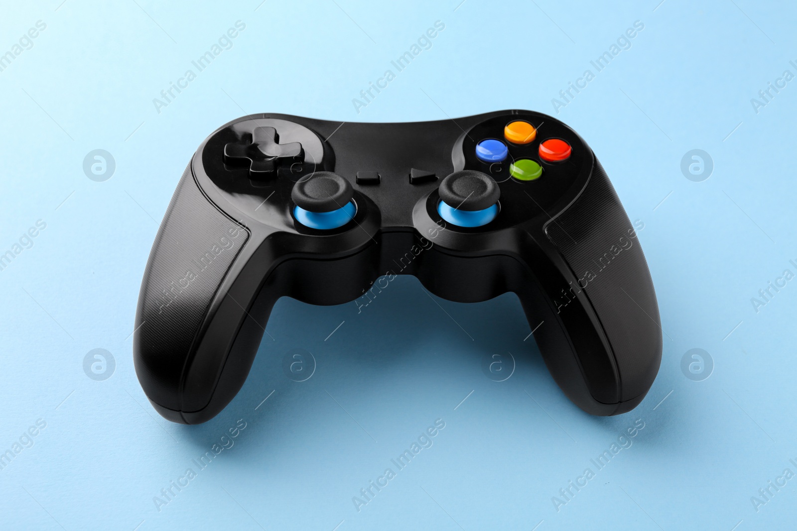 Photo of Wireless game controller on light blue background