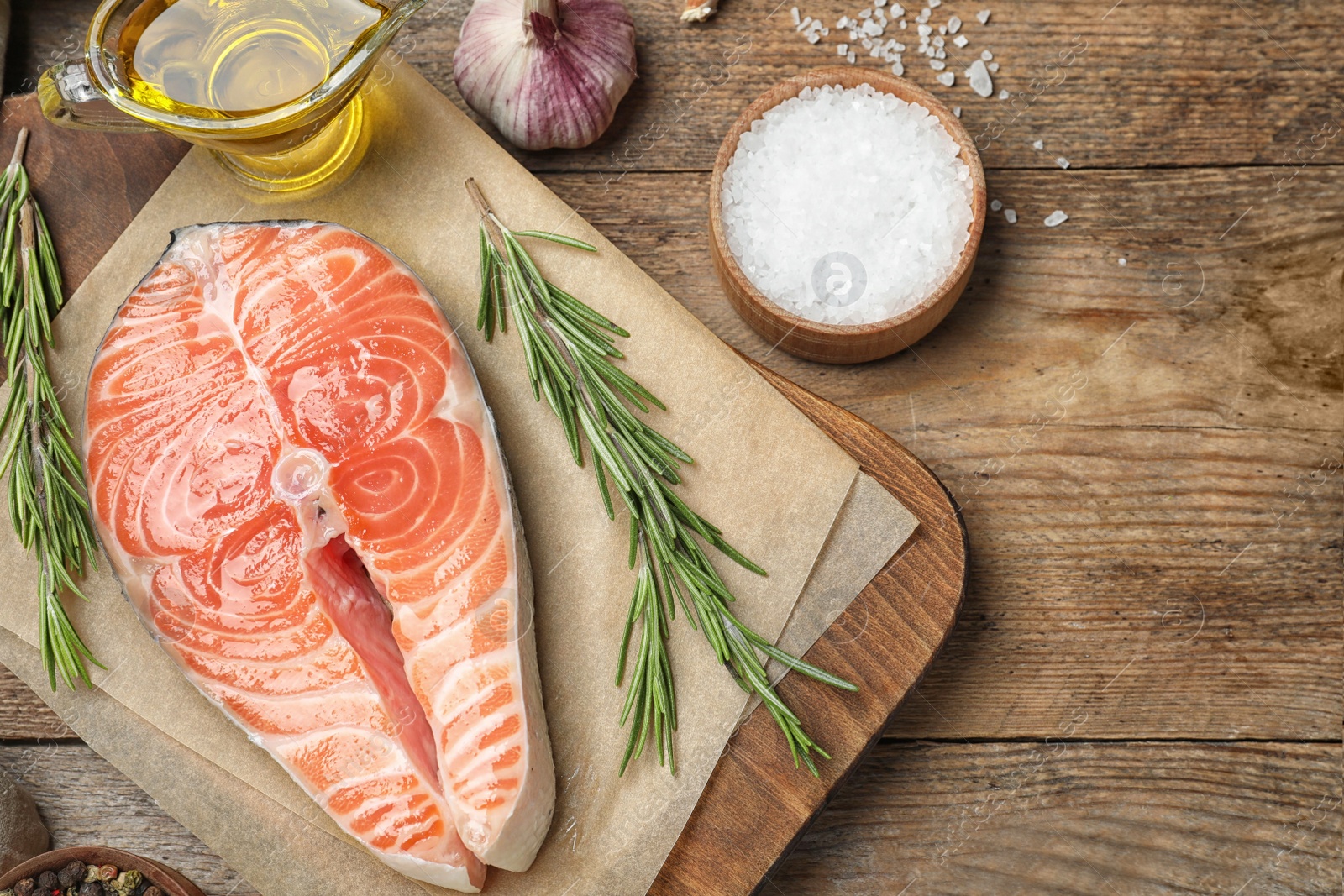 Photo of Flat lay composition with fresh raw salmon and products on wooden table. Fish delicacy