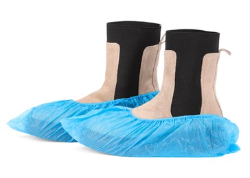 Photo of Women's boots in blue shoe covers isolated on white