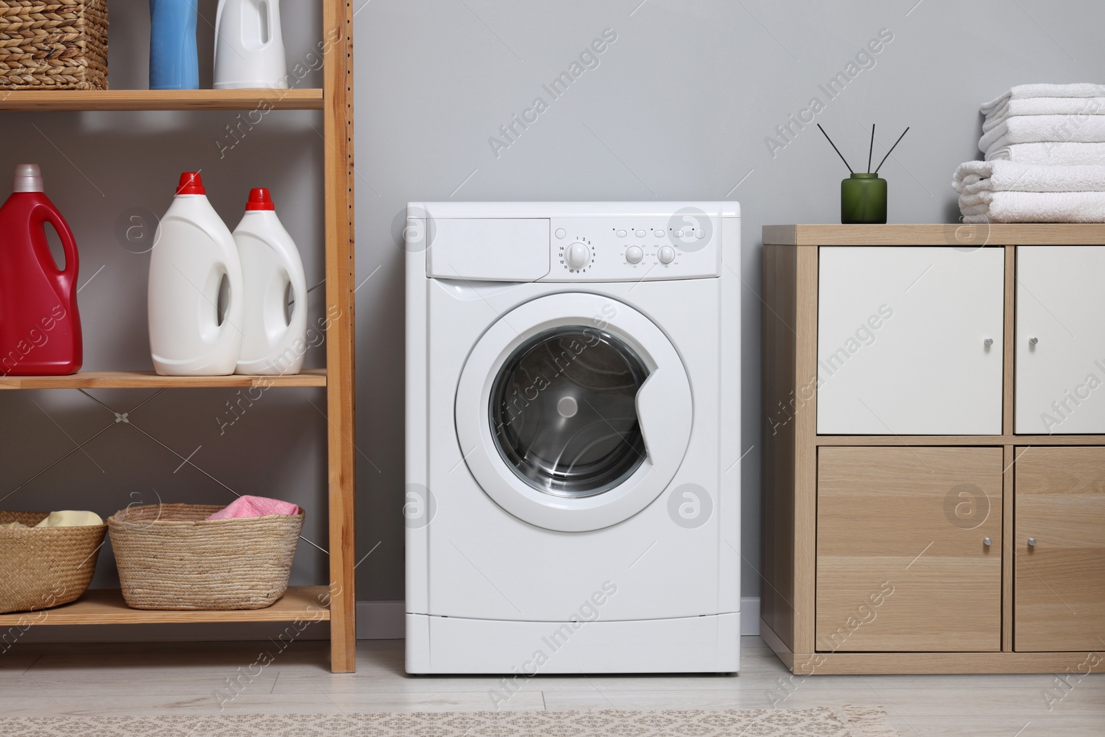 Photo of Laundry room interior with washing machine and furniture