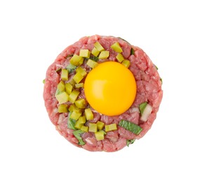 Tasty beef steak tartare served with yolk and pickled cucumber isolated on white, top view