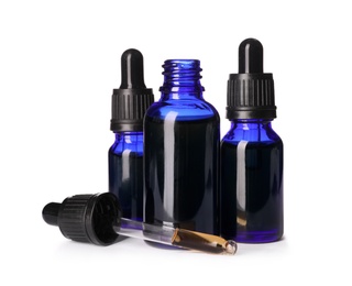 Photo of Cosmetic bottles of essential oils on white background