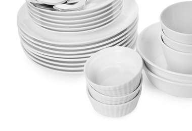 Photo of Set of clean tableware on white background, closeup. Washing dishes