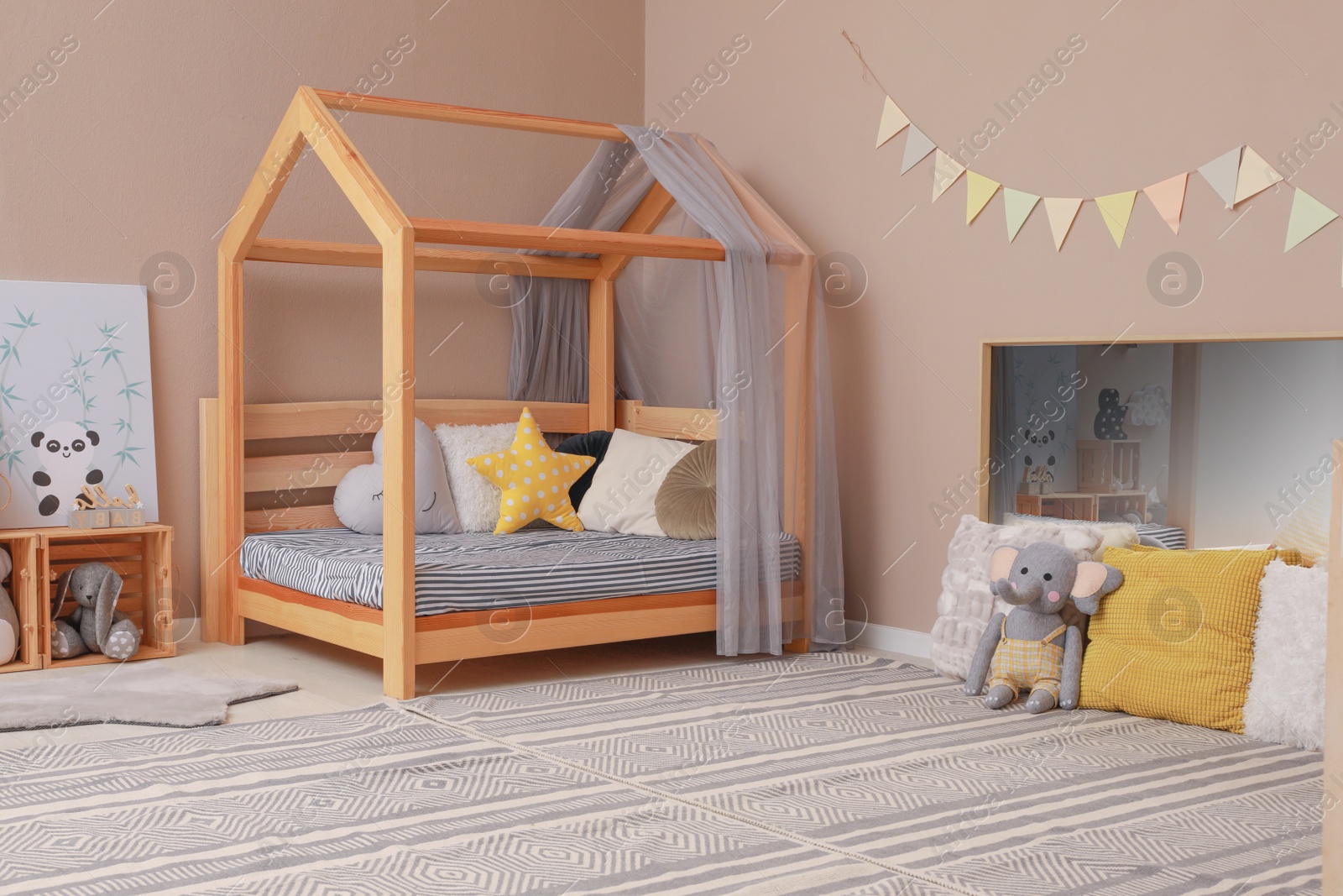 Photo of Stylish child room interior with comfortable floor bed