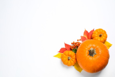 Photo of Flat lay composition with ripe pumpkins and autumn leaves on white background, space for text. Happy Thanksgiving day