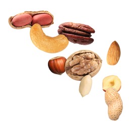 Image of Many different nuts in air on white background