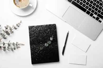 Photo of Flat lay composition with glittering notebook and laptop on white background