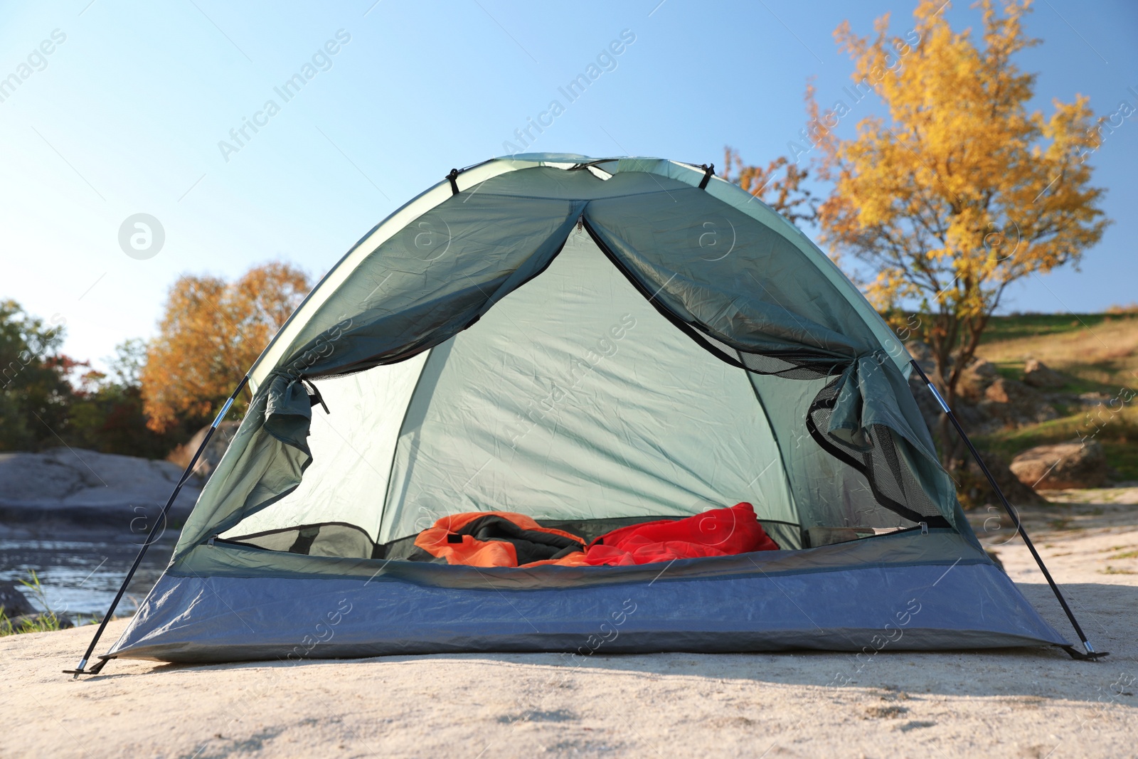 Photo of Camping tent with sleeping bags in wilderness