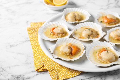 Photo of Fried scallops in shells on white marble table, closeup. Space for text