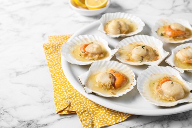 Fried scallops in shells on white marble table, closeup. Space for text