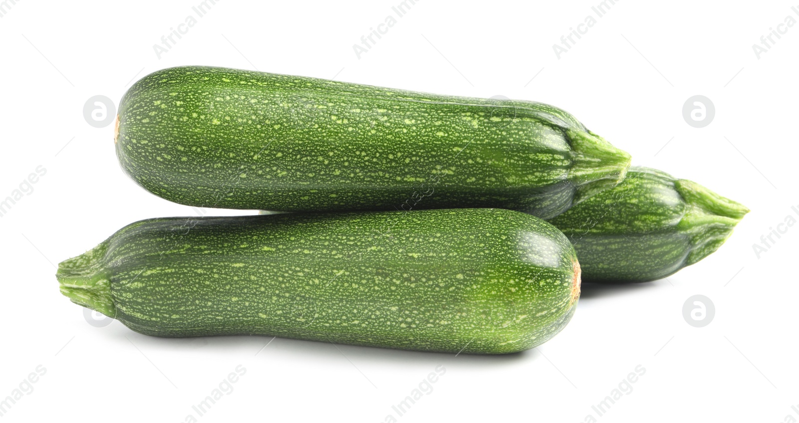 Photo of Fresh raw ripe zucchinis on white background