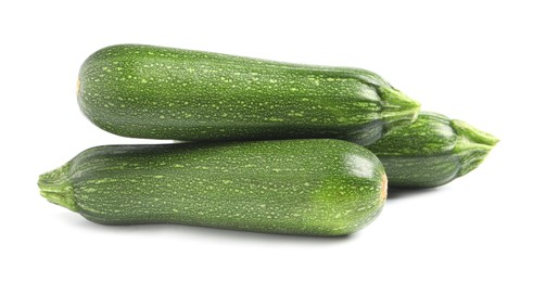 Photo of Fresh raw ripe zucchinis on white background