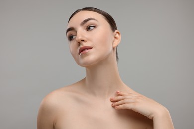 Portrait of beautiful woman on grey background