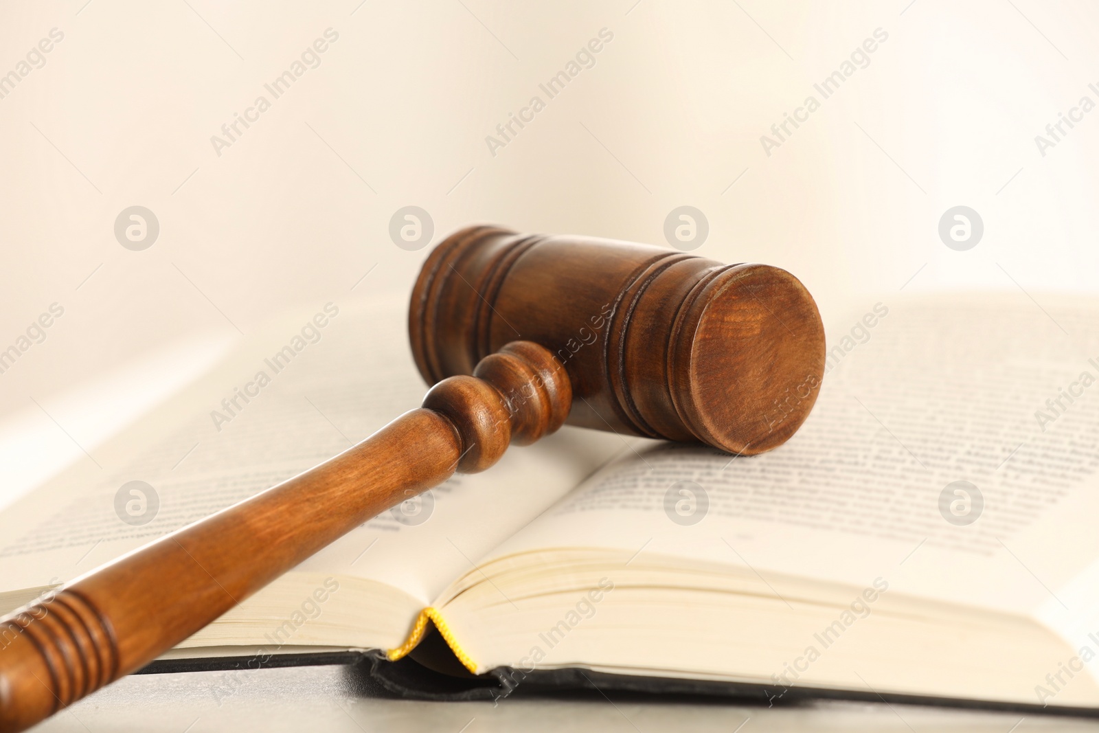 Photo of Law concept. Gavel and book on light table, closeup