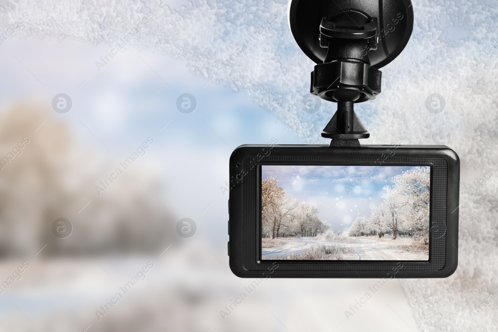 Image of Modern dashboard camera mounted in car, view of road during driving