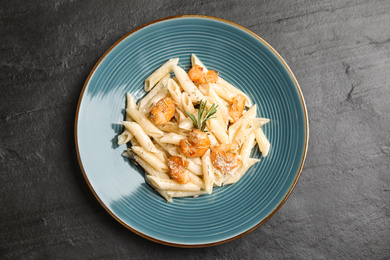 Delicious pasta with shrimps on black table, top view