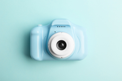 Photo of Toy camera on light blue background, top view. Future photographer