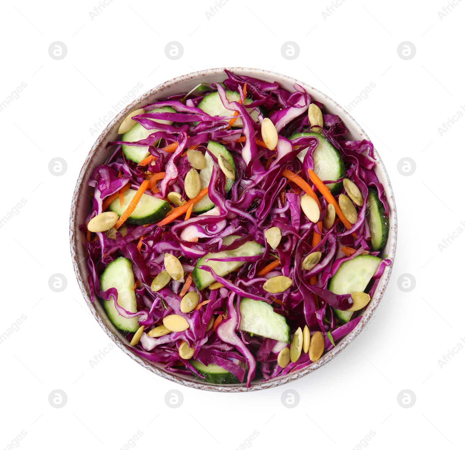 Photo of Tasty salad with red cabbage and pumpkin seeds in bowl isolated on white, top view