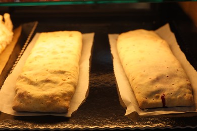 Delicious strudels on counter in bakery shop, closeup