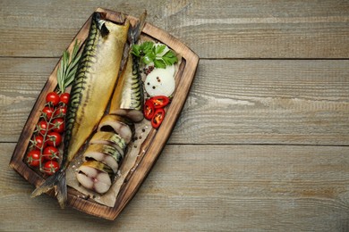 Delicious smoked mackerels and different products on wooden table, top view. Space for text