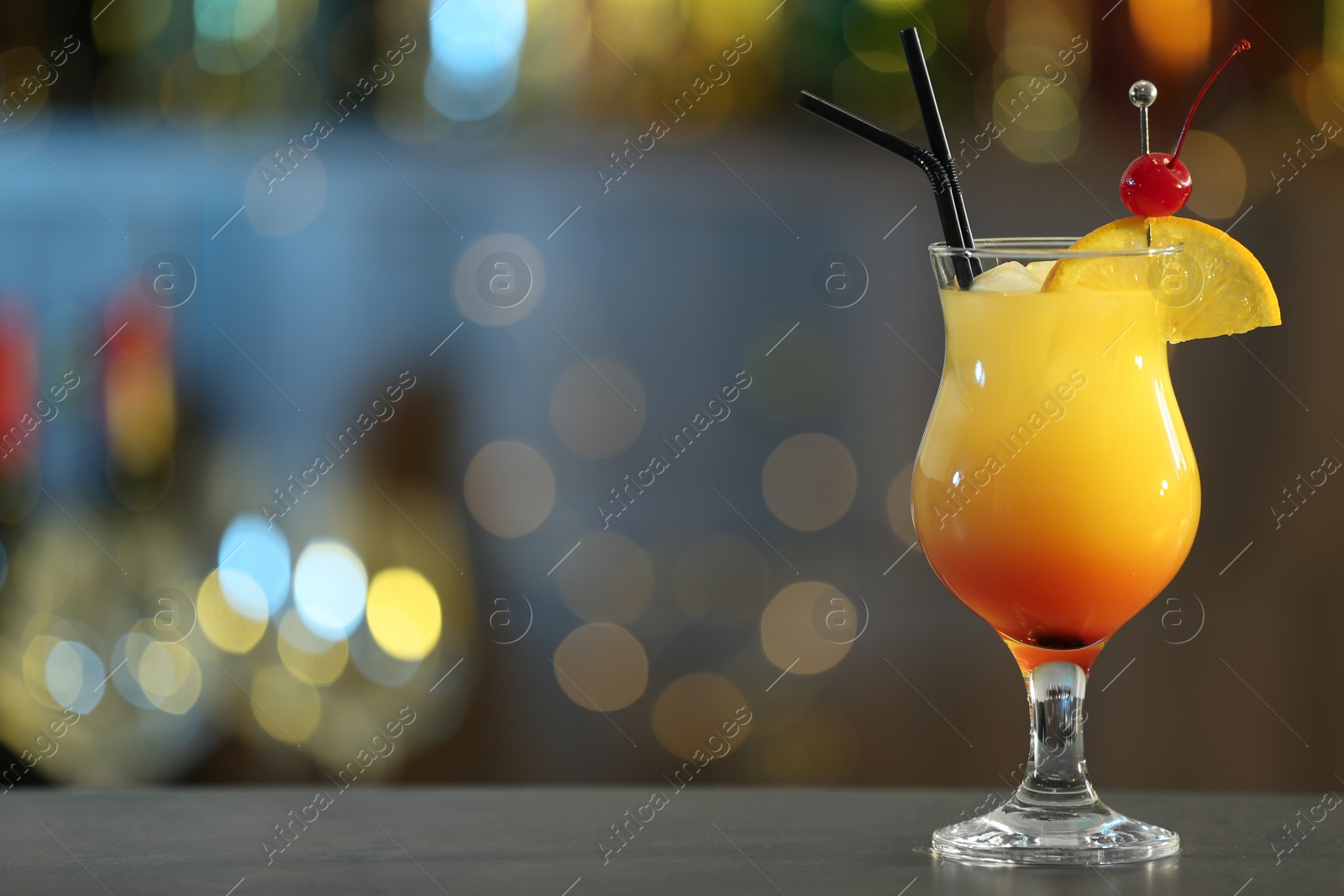 Photo of Just made appetizing cocktail Sex on the Beach in bar. Space for text