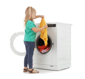 Photo of Cute little girl with laundry near washing machine on white background
