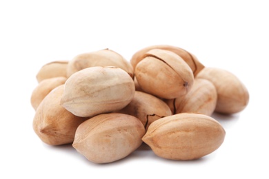 Heap of pecan nuts in shell on white background