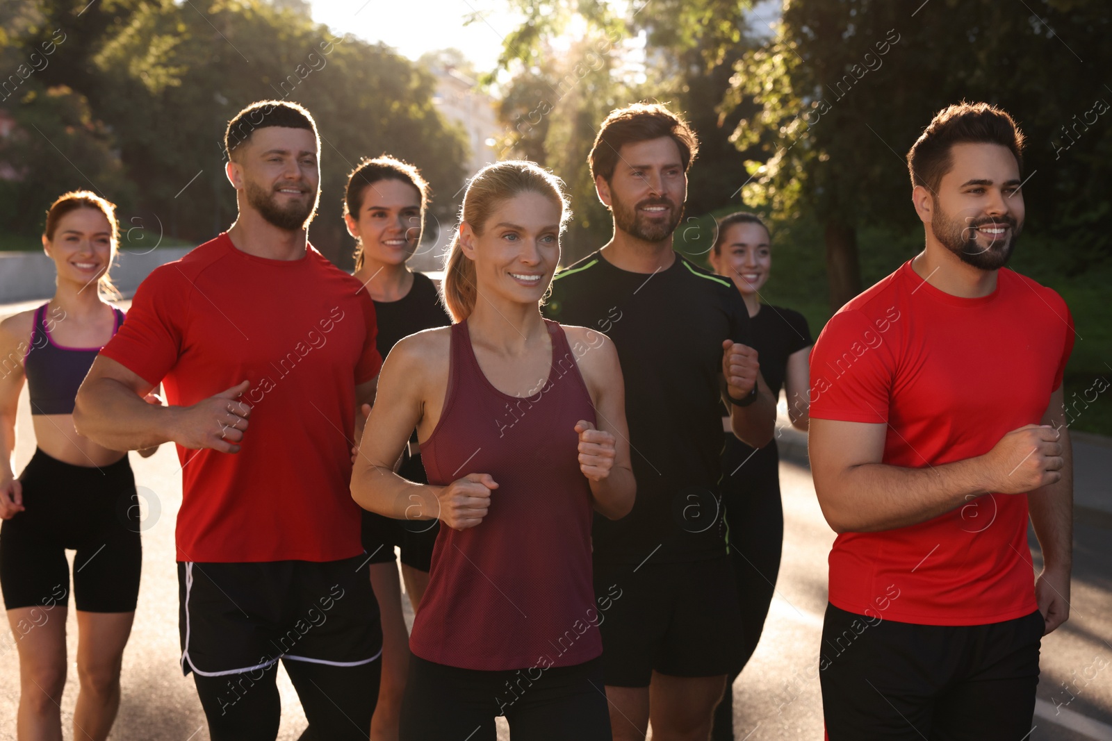 Photo of Group of people running outdoors on sunny day