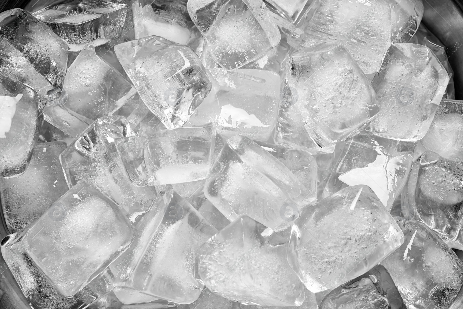 Photo of Bucket with ice cubes as background, closeup