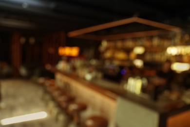 Photo of Blurred view of stylish modern bar interior with bokeh effect