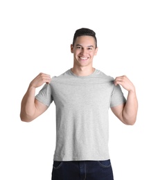 Young man in grey t-shirt on white background. Mockup for design