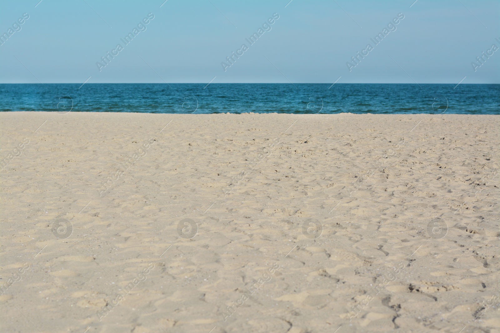 Photo of Beautiful view of sandy beach near sea on sunny day