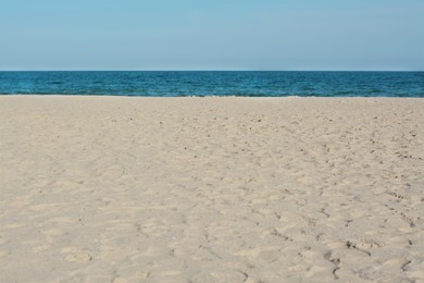Photo of Beautiful view of sandy beach near sea on sunny day
