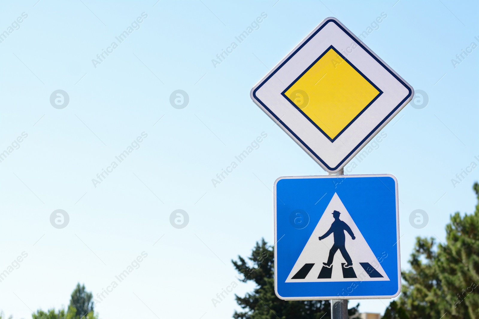 Photo of Pedestrian Crossing and Priority road signs outdoors. Space for text